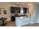 Modern kitchen featuring stainless steel appliances, dark cabinetry, and a bright breakfast bar at 7336 Ivory Ter, New Port Richey, FL 34655