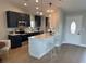 Modern kitchen featuring stainless steel appliances, dark cabinetry, and a bright breakfast bar at 7336 Ivory Ter, New Port Richey, FL 34655