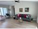 Bright living room with vaulted ceilings, ceiling fan, neutral decor, and plenty of space at 7336 Ivory Ter, New Port Richey, FL 34655