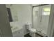 Updated bathroom with a sleek glass shower, modern fixtures, and white tile at 807 S Castle Ct, Tampa, FL 33612
