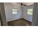 Cozy bedroom with two windows providing natural light and vinyl floors at 807 S Castle Ct, Tampa, FL 33612