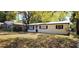 Charming single-story home featuring a metal roof and a well-maintained lawn at 807 S Castle Ct, Tampa, FL 33612