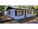 Charming home exterior featuring black shutters, an entry door, and manicured landscaping at 807 S Castle Ct, Tampa, FL 33612