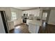 Updated kitchen with stainless steel appliances, white cabinets, breakfast bar, and tiled backsplash at 807 S Castle Ct, Tampa, FL 33612