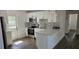 Updated kitchen with stainless steel appliances, white cabinets, and a breakfast bar at 807 S Castle Ct, Tampa, FL 33612