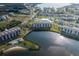 Aerial view of waterfront community featuring multiple buildings, a pool, a lake, and a beautiful landscape at 8251 Brent St # 918, Port Richey, FL 34668