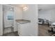 Bright bathroom vanity with granite counters next to the toilet and bedroom at 8251 Brent St # 918, Port Richey, FL 34668