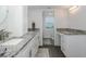 Bathroom features dual vanities with granite countertop and a doorway to the toilet at 8251 Brent St # 918, Port Richey, FL 34668