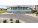 Inviting clubhouse exterior featuring a covered porch and ample parking, perfect for community gatherings and events at 8251 Brent St # 918, Port Richey, FL 34668