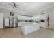 Modern kitchen features a large island, granite countertops, stainless steel appliances, and bright white cabinetry at 8251 Brent St # 918, Port Richey, FL 34668