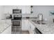 Modern kitchen featuring stainless steel appliances, granite countertops, and a stainless steel sink at 8251 Brent St # 918, Port Richey, FL 34668