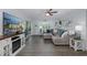 Open living room with large sectional, decorative fireplace, and access to screened patio at 8251 Brent St # 918, Port Richey, FL 34668
