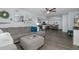 Bright open-concept living space with gray sectional sofa and modern decor at 8251 Brent St # 918, Port Richey, FL 34668