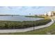 Tranquil waterfront view with lush landscaping and a walking path at 8251 Brent St # 918, Port Richey, FL 34668