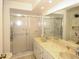 This bathroom has a double vanity and a shower with sliding glass doors at 9321 Whitstone Ct, New Port Richey, FL 34655