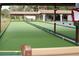 Covered bocce ball court featuring a smooth green surface and seating areas for relaxation at 9321 Whitstone Ct, New Port Richey, FL 34655