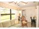 Comfortable living area with a view of the yard, featuring a couch, laundry area, and natural light at 9321 Whitstone Ct, New Port Richey, FL 34655