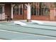 Outdoor shuffleboard court featuring an open-air setup and seating areas at 9321 Whitstone Ct, New Port Richey, FL 34655
