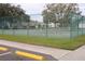 Well-maintained tennis courts surrounded by lush greenery, perfect for recreation at 9321 Whitstone Ct, New Port Richey, FL 34655