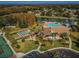 An aerial view of the community clubhouse, pool, tennis courts, shuffleboard, and parking at 9336 Cape Charles Ave, New Port Richey, FL 34655
