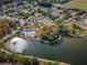 Aerial view of a pool and dock, complemented by lush greenery and the community's amenities at 9336 Cape Charles Ave, New Port Richey, FL 34655