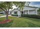 Charming single-story home with a well-maintained lawn, mature tree, and a welcoming front porch at 9336 Cape Charles Ave, New Port Richey, FL 34655
