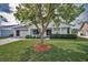 Charming one-story home featuring a well-maintained lawn, mature tree, and inviting front porch at 9336 Cape Charles Ave, New Port Richey, FL 34655