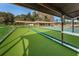Bocce ball courts and shuffleboard with covered seating areas and lush green surroundings at 9336 Cape Charles Ave, New Port Richey, FL 34655