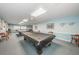 Game room featuring pool tables, comfortable seating, and a bright ambiance, ideal for leisure and entertainment at 9336 Cape Charles Ave, New Port Richey, FL 34655