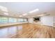 Spacious hall with wood flooring, bright windows and neutral walls, perfect for community gatherings and activities at 9336 Cape Charles Ave, New Port Richey, FL 34655