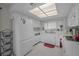 Bright kitchen with clean white appliances, plenty of counter space, and an overhead skylight at 9336 Cape Charles Ave, New Port Richey, FL 34655