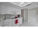 Practical kitchen featuring white appliances, abundant storage, and a minimalist design at 9336 Cape Charles Ave, New Port Richey, FL 34655