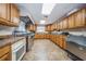 Large kitchen featuring stainless steel appliances, ample counter space, and durable tile flooring, perfect for catering at 9336 Cape Charles Ave, New Port Richey, FL 34655