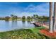 Beautiful lake view with a wooden dock and lush landscaping, creating a serene atmosphere at 9336 Cape Charles Ave, New Port Richey, FL 34655
