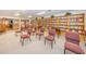 Cozy library space filled with bookshelves, comfortable chairs, and tables, creating a welcoming reading environment at 9336 Cape Charles Ave, New Port Richey, FL 34655
