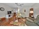 Comfortable living room featuring hardwood floors, ample space, and a ceiling fan at 9336 Cape Charles Ave, New Port Richey, FL 34655