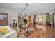 Bright living room with wood floors, comfortable seating, adjacent dining area, and open floor plan at 9336 Cape Charles Ave, New Port Richey, FL 34655
