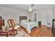 Bedroom features a ceiling fan, closet, and hardwood floors at 9336 Cape Charles Ave, New Port Richey, FL 34655