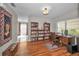 Home office featuring built-in bookshelves, a wooden desk, and ample natural light at 9336 Cape Charles Ave, New Port Richey, FL 34655