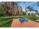 Park setting featuring blue picnic table, large grassy areas, and mature trees on a clear day at 9336 Cape Charles Ave, New Port Richey, FL 34655