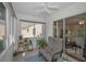 Enclosed patio with tile flooring, large windows, and comfortable seating at 9336 Cape Charles Ave, New Port Richey, FL 34655