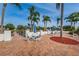 Outdoor patio area with seating, umbrellas, and views of the lake and lush landscaping at 9336 Cape Charles Ave, New Port Richey, FL 34655