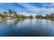 Scenic pond with a water fountain, surrounded by green lawns and trees, creating a peaceful community setting at 9336 Cape Charles Ave, New Port Richey, FL 34655