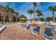 Pool deck featuring lounge chairs, a gazebo, and ample seating under palm trees, ideal for relaxing by the water at 9336 Cape Charles Ave, New Port Richey, FL 34655