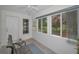 Bright sunroom featuring large windows and access to the backyard, providing ample natural light and outdoor views at 9336 Cape Charles Ave, New Port Richey, FL 34655