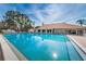 Large community swimming pool with lounge chairs and a clubhouse in the background at 9336 Cape Charles Ave, New Port Richey, FL 34655