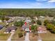 Expansive aerial view of a home with a large lot, mature trees, and convenient access to nearby amenities at 10399 Elgin Blvd, Spring Hill, FL 34608
