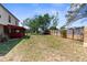 Spacious backyard with green grass and a partial view of the back of the home at 10399 Elgin Blvd, Spring Hill, FL 34608