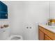 Bathroom featuring a toilet, vanity with drawers, towel and decorative items at 10399 Elgin Blvd, Spring Hill, FL 34608