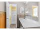 Bathroom featuring a white vanity, wood paneling and a glimpse of the shower at 10399 Elgin Blvd, Spring Hill, FL 34608